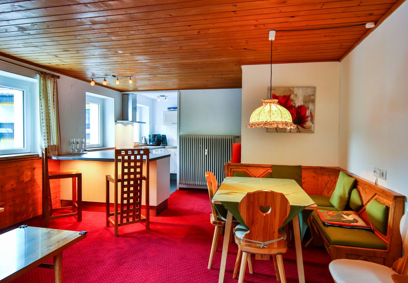 Living area with table and kitchen in the Dagmar Alpenhaus Montafon