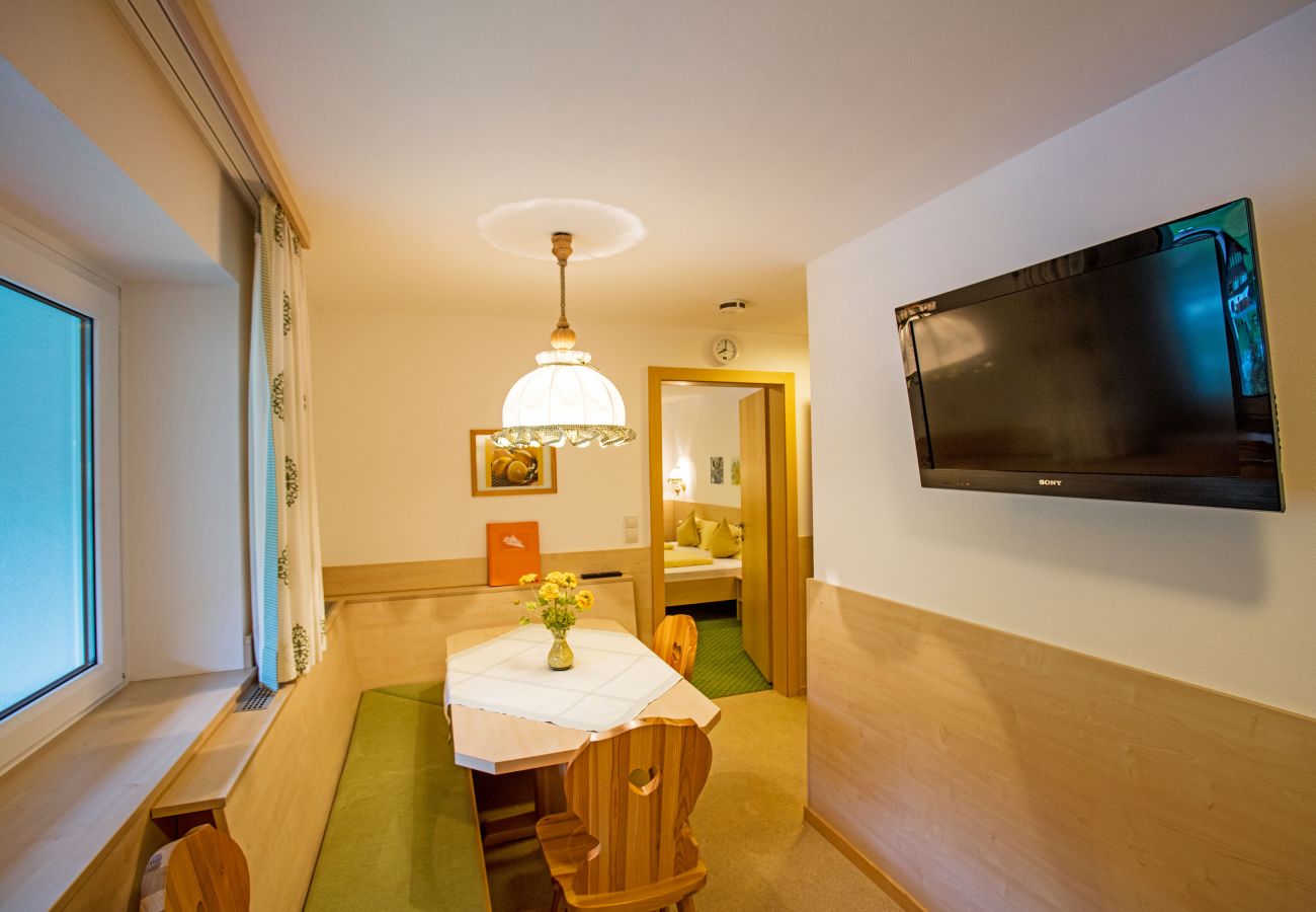 Living area with a table in the Delia Alpenhaus Montafon